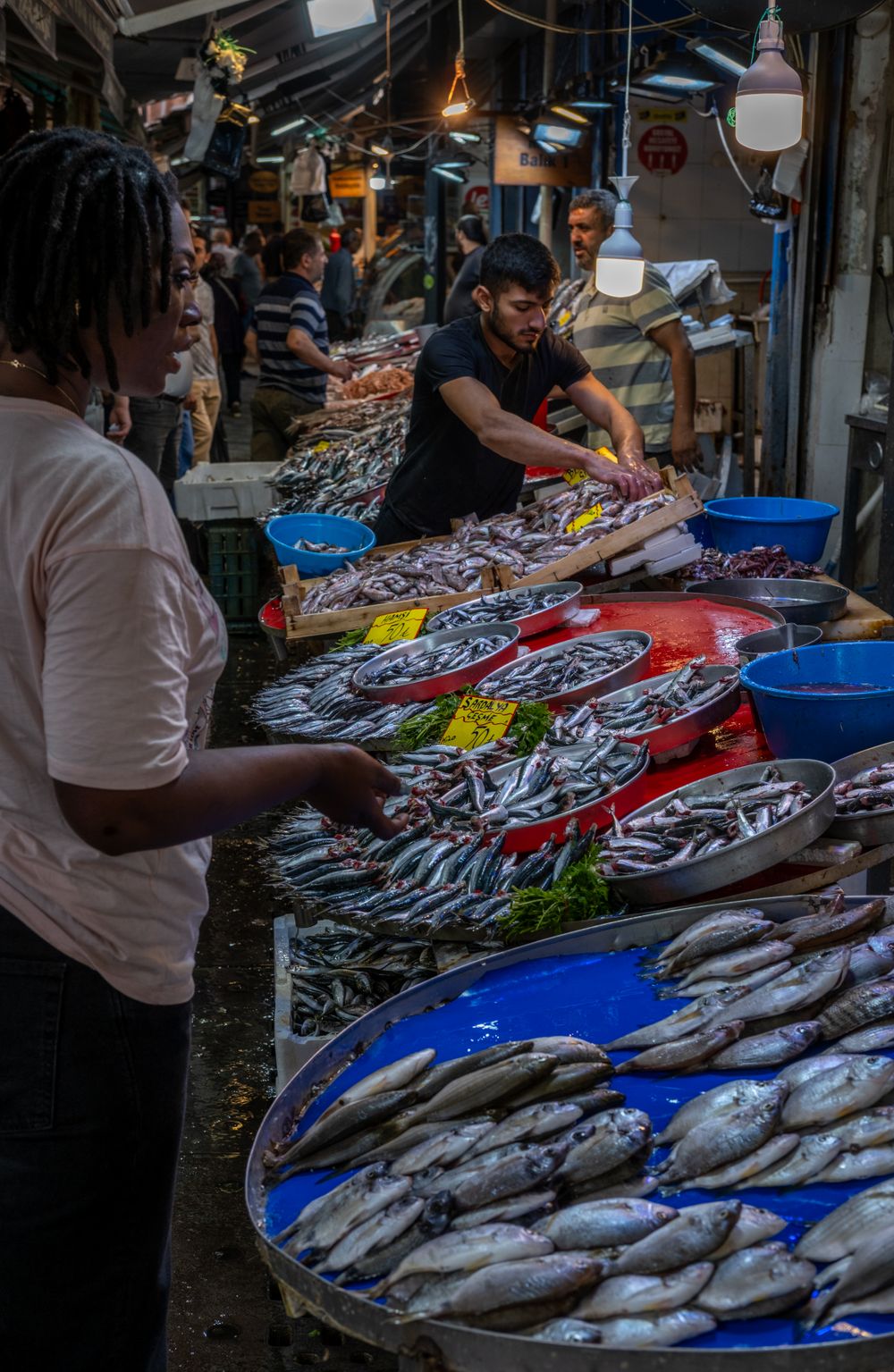 Customer choosing fresh fish at the market