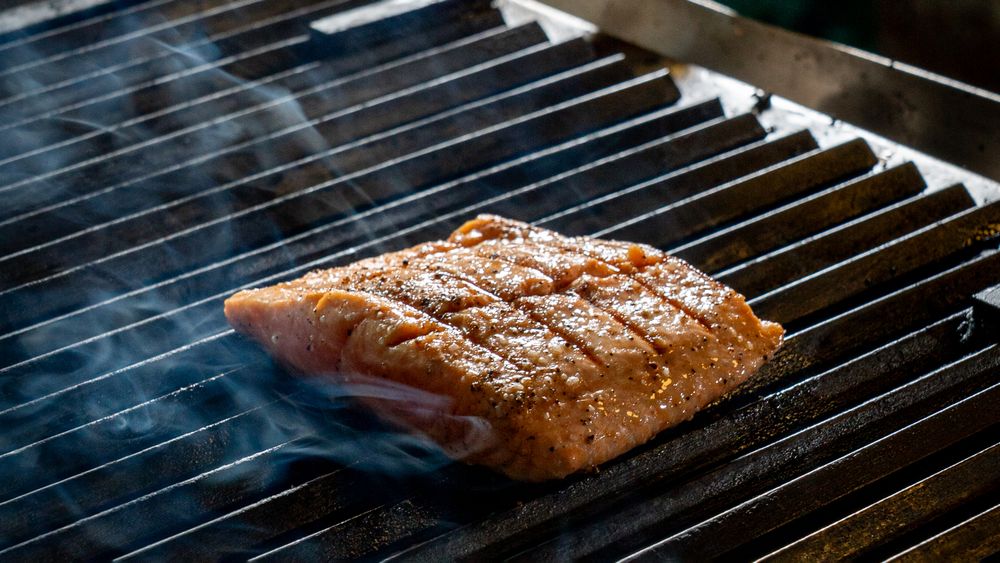 Fish hitting the grill in the kitchen